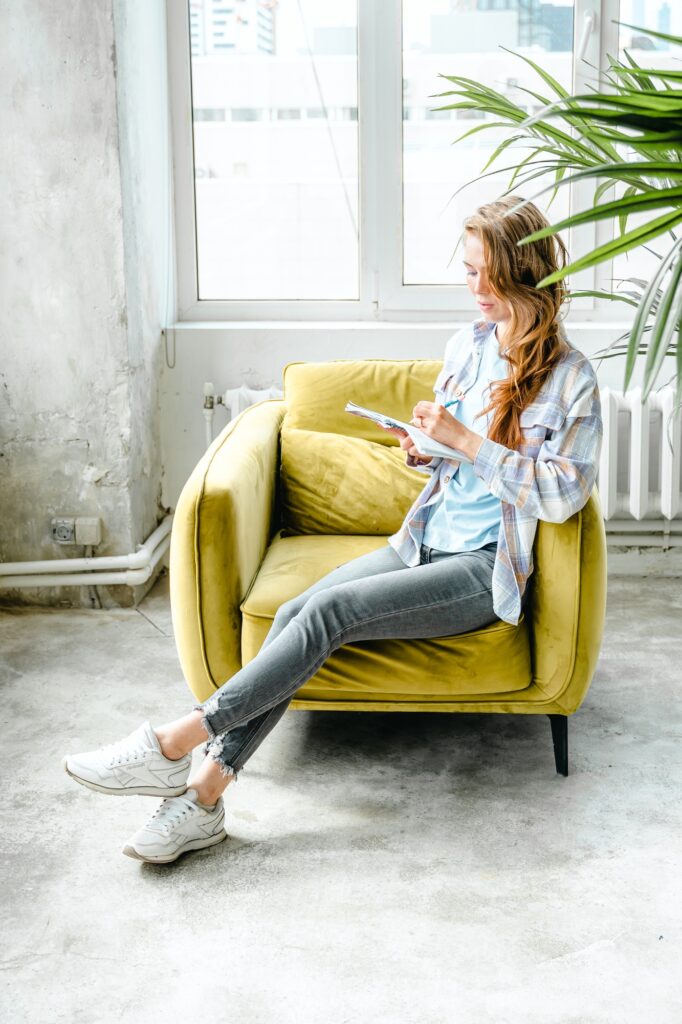 Young beautiful long haired college student girl in casual shirt with notebook,organizer pen